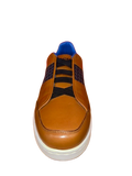 The Maceoo Casual Brown shoes feature black laces, textured side panels, and a white sole, viewed from the front.