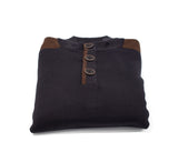 A folded Polo Sweater by Fashion International in black, featuring brown shoulder patches and three buttons on the front.