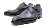 A pair of Ugo Vasare Edward Sr. black leather monk shoes with a buckle.