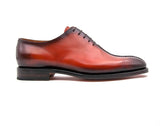 A men's red leather Derrick oxford shoe with Goodyear welt construction on a white background, by Ugo Vasare.