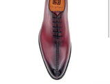 A men's burgundy oxford shoe named Derrick made by Ugo Vasare with calfskin leather and featuring goodyear welt construction on a white background.